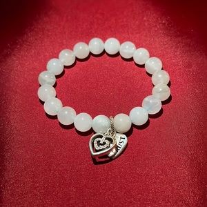White beaded Brighton bracelet with trust/heart charms